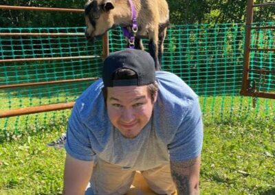 alberta campground | goat standing on man